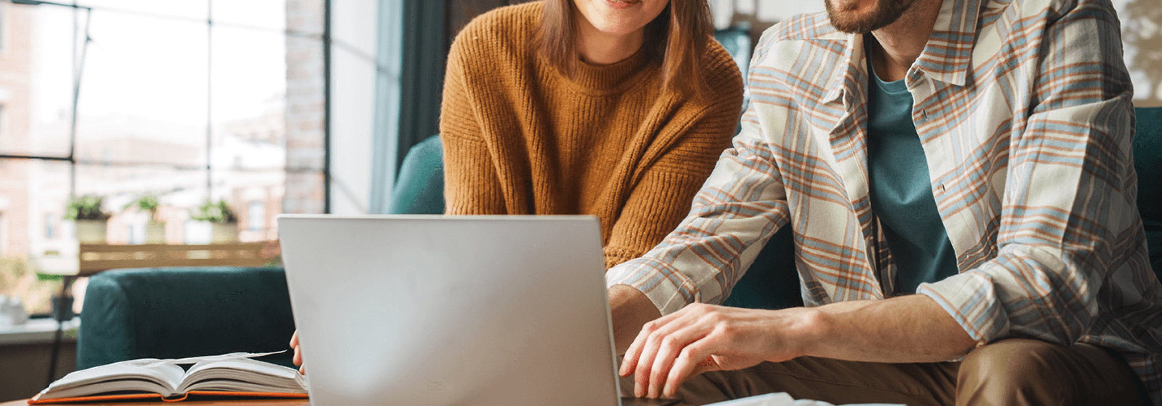 Two people sitting at a table, promoting fast and easy loan applications for churches.