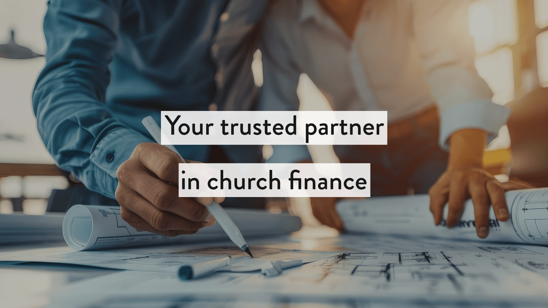 Close-up of people reviewing blueprints with text overlay: ‘Your trusted partner in church finance.’